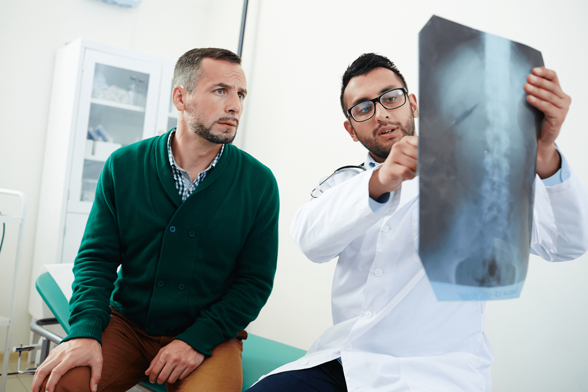 Doctor explaining X-ray results to a patient.